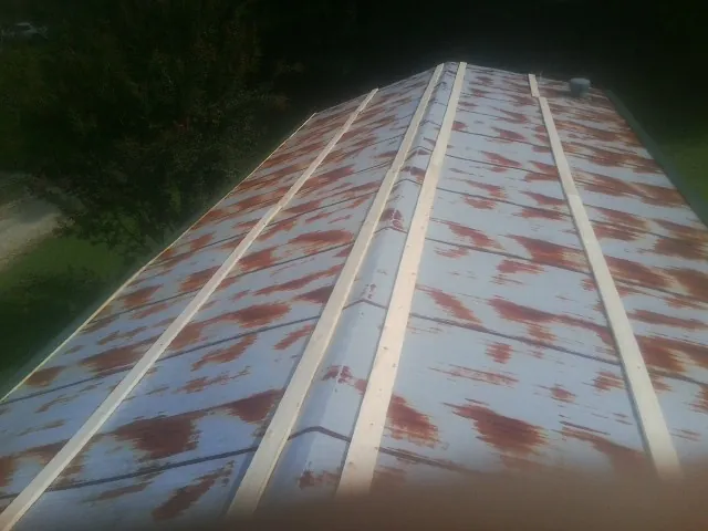 Rusted metal roof panels with new wood purlins before replacement — Storm Damage Roof Repair in Jean by Roofing Brothers